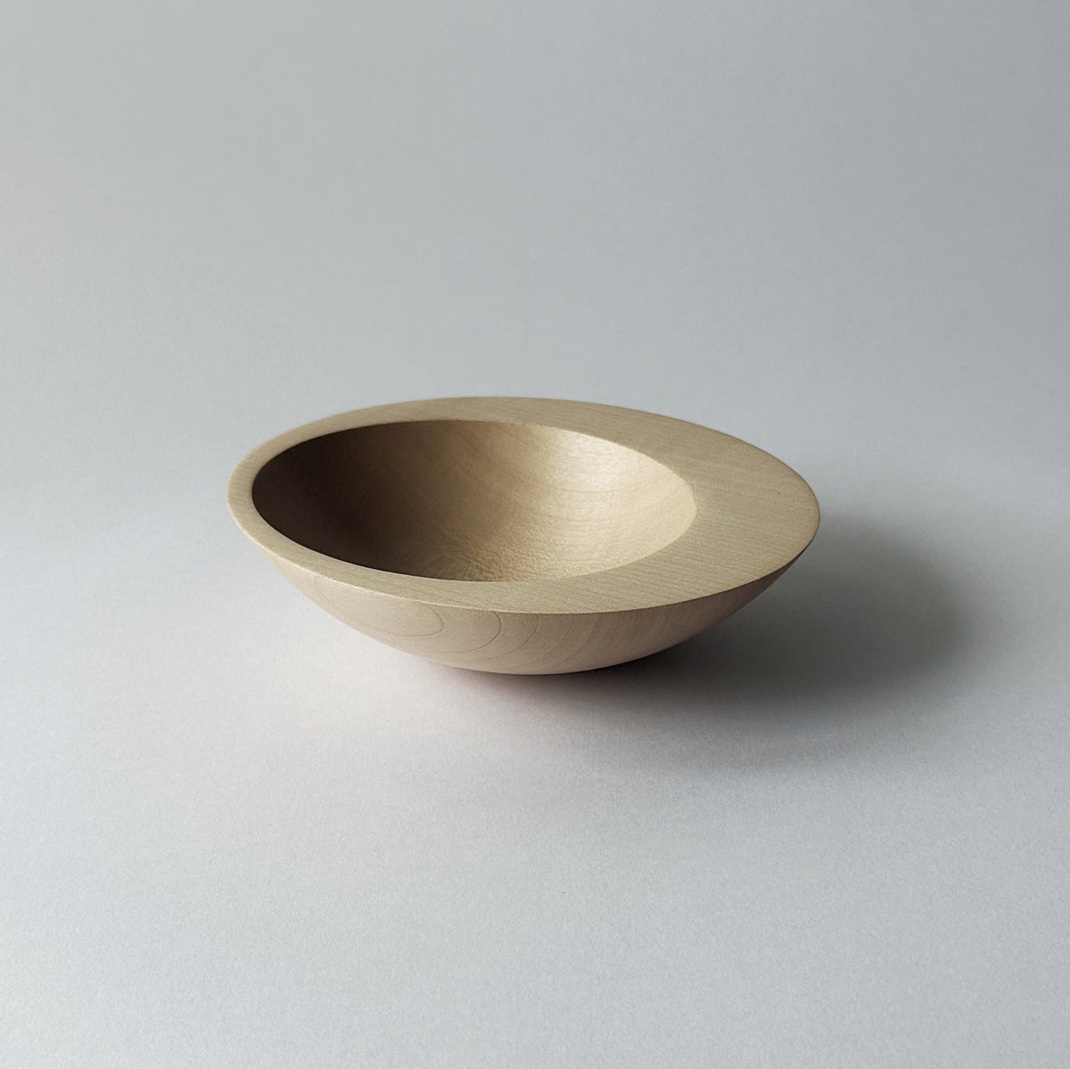 Tilted crescent bowl in sycamore