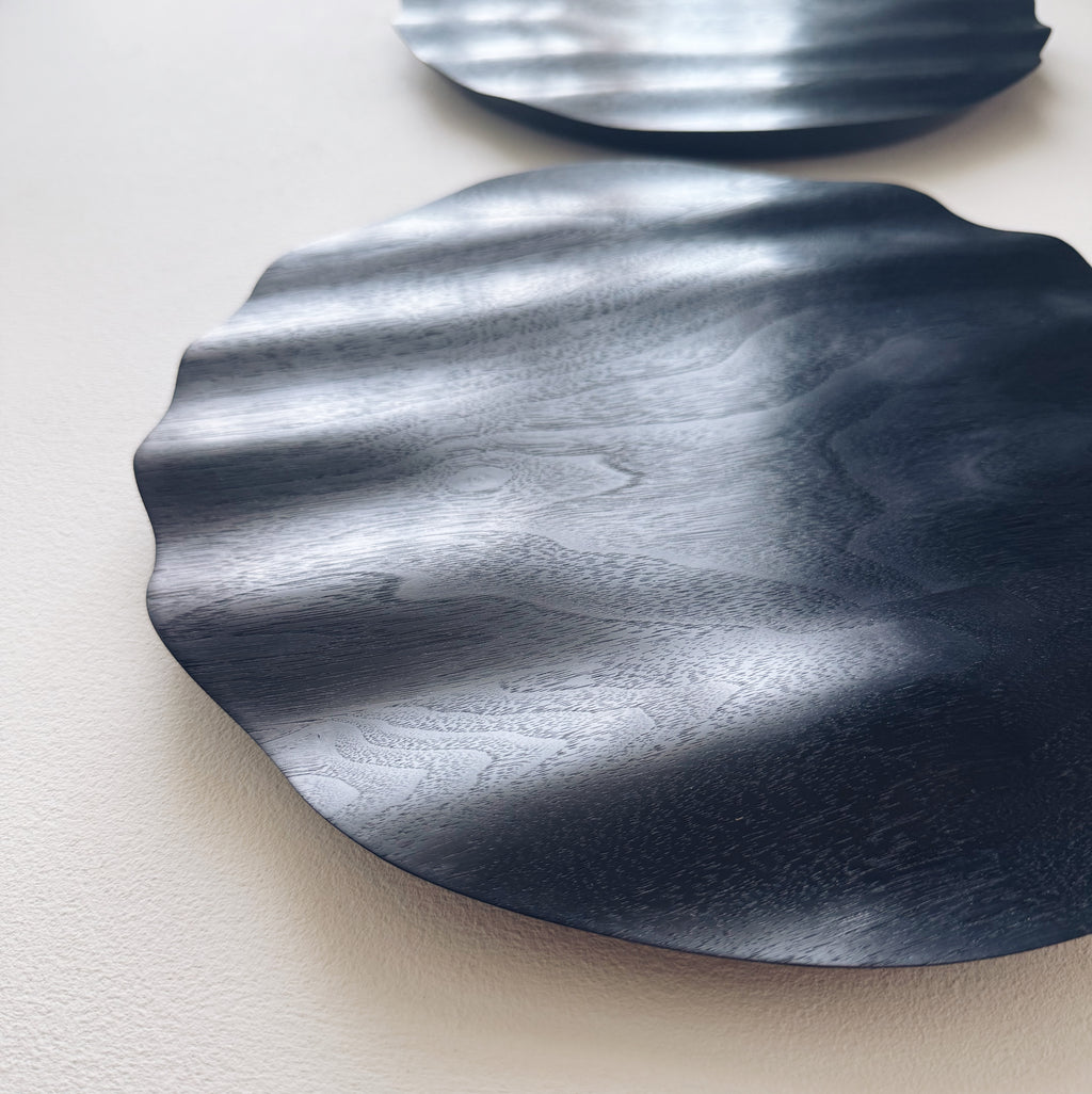 Wavy charger plate in ebonised walnut