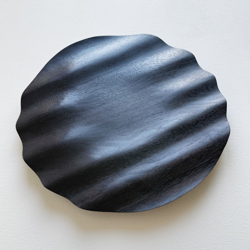 Wavy charger plate in ebonised walnut