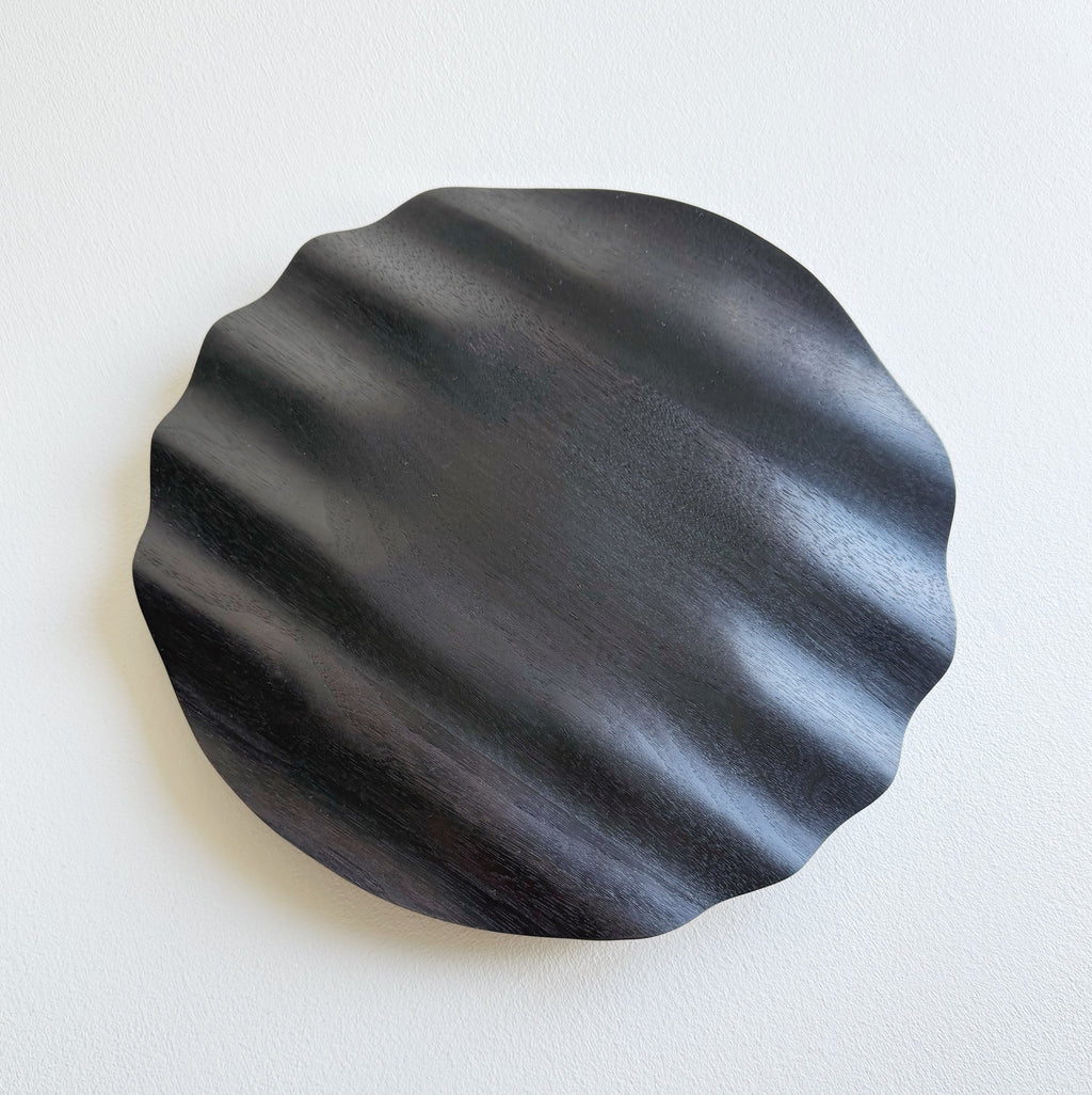 Wavy charger plate in ebonised walnut