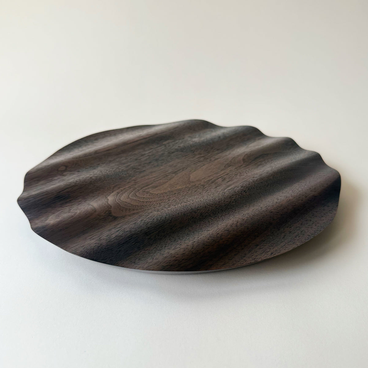 Wavy charger plate in vintage black walnut