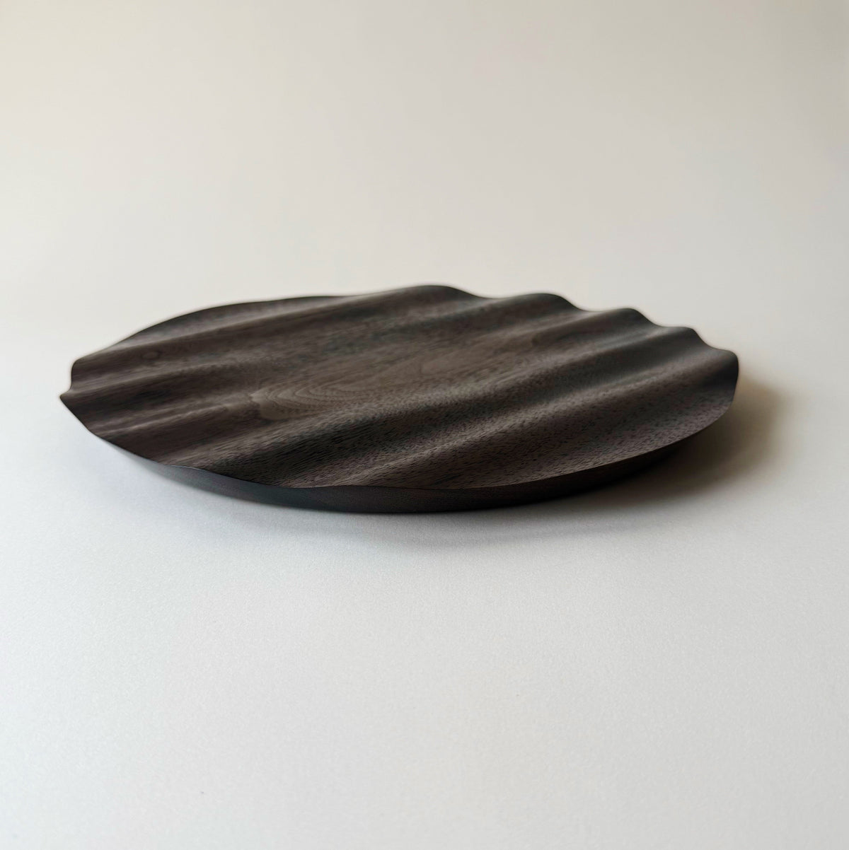 Wavy charger plate in vintage black walnut